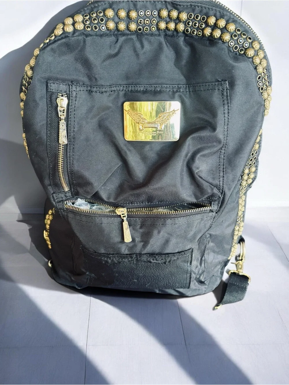 Jean Studded Backpack designed with an edgy  streetwear aesthetic.